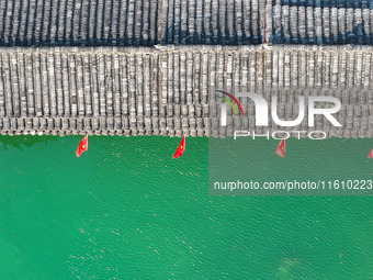 National flags are displayed on the Qiyan Bridge to celebrate China's National Day in Tongren, China, on September 26, 2024. (