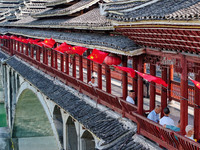 National flags are displayed on the Qiyan Bridge to celebrate China's National Day in Tongren, China, on September 26, 2024. (