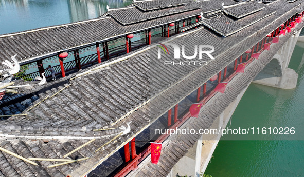 National flags are displayed on the Qiyan Bridge to celebrate China's National Day in Tongren, China, on September 26, 2024. 