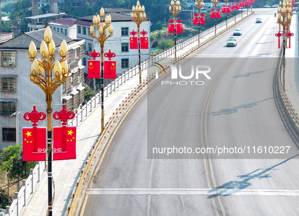 National flags are displayed on the Qiyan Bridge to celebrate China's National Day in Tongren, China, on September 26, 2024. 