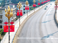 National flags are displayed on the Qiyan Bridge to celebrate China's National Day in Tongren, China, on September 26, 2024. (