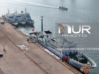 Coast guard ships are seen at a dock in Yantai, China, on September 26, 2024. (