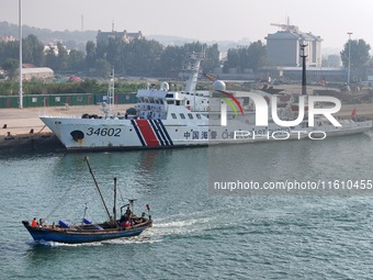 Coast guard ships are seen at a dock in Yantai, China, on September 26, 2024. (