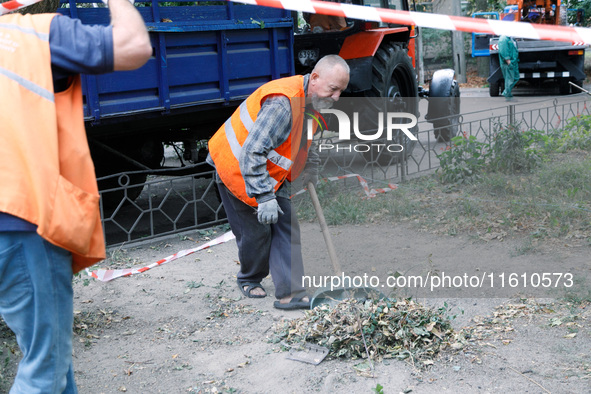 Utility workers eliminate the consequences of falling debris from a downed Russian ''Shahed'' drone in the Pechersk district of Kyiv, Ukrain...