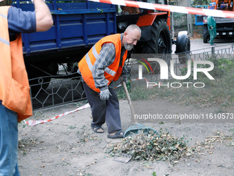 Utility workers eliminate the consequences of falling debris from a downed Russian ''Shahed'' drone in the Pechersk district of Kyiv, Ukrain...