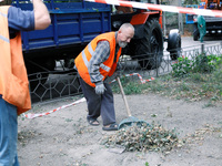 Utility workers eliminate the consequences of falling debris from a downed Russian ''Shahed'' drone in the Pechersk district of Kyiv, Ukrain...