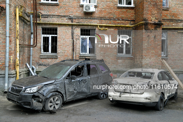 Cars damaged by falling wreckage of a downed Russian 'Shahed' drone in the Pechersk district of Kyiv, Ukraine, on September 26, 2024. NO USE...