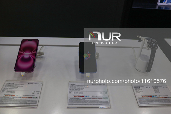 Apple Series 10 Watch (Right), Apple's latest iPhone 16 (Center), and Apple's latest iPhone 16 Plus (Left) are displayed for sale at Master...