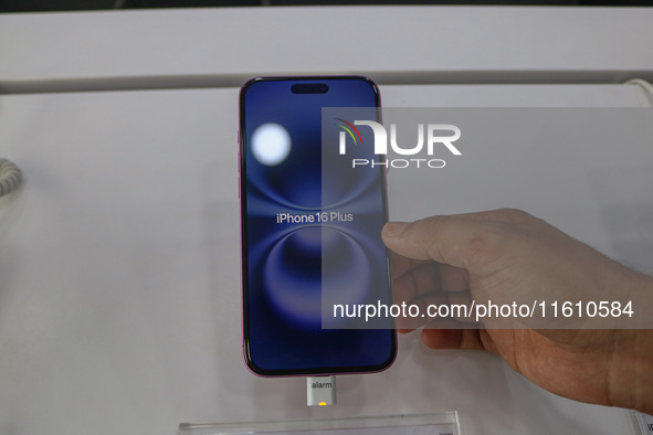 A customer checks Apple's latest iPhone 16 Plus series displayed for sale at Master Arts Shop in Srinagar, Jammu and Kashmir, on September 2...