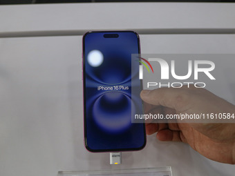 A customer checks Apple's latest iPhone 16 Plus series displayed for sale at Master Arts Shop in Srinagar, Jammu and Kashmir, on September 2...