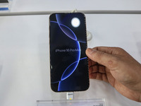 A customer checks Apple's latest iPhone 16 Pro Max series displayed for sale at Master Arts Shop in Srinagar, Jammu and Kashmir, on Septembe...