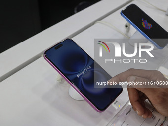 A customer checks Apple's latest iPhone 16 Plus series displayed for sale at Master Arts Shop in Srinagar, Jammu and Kashmir, on September 2...