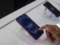 A customer checks Apple's latest iPhone 16 Plus series displayed for sale at Master Arts Shop in Srinagar, Jammu and Kashmir, on September 2...