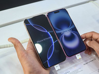 A customer checks Apple's latest iPhone 16 Plus (right) and Apple's latest iPhone 16 Pro Max (left) series displayed for sale at Master Arts...