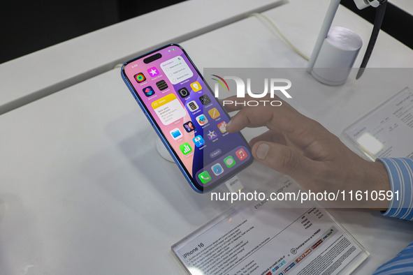 A customer checks Apple's latest iPhone 16 series displayed for sale at Master Arts Shop in Srinagar, Jammu and Kashmir, on September 26, 20...