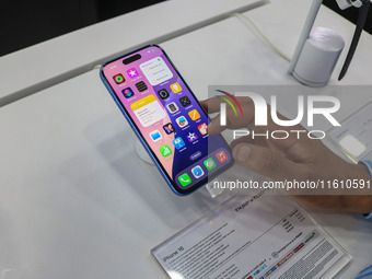 A customer checks Apple's latest iPhone 16 series displayed for sale at Master Arts Shop in Srinagar, Jammu and Kashmir, on September 26, 20...