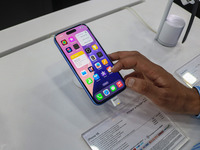 A customer checks Apple's latest iPhone 16 series displayed for sale at Master Arts Shop in Srinagar, Jammu and Kashmir, on September 26, 20...