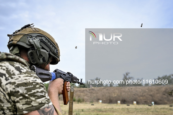 A serviceman of the 65th Separate Mechanized Brigade of the Armed Forces of Ukraine takes aim during combat cohesion in Ukraine, on Septembe...