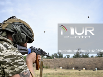 A serviceman of the 65th Separate Mechanized Brigade of the Armed Forces of Ukraine takes aim during combat cohesion in Ukraine, on Septembe...