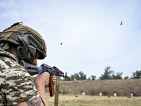 A serviceman of the 65th Separate Mechanized Brigade of the Armed Forces of Ukraine takes aim during combat cohesion in Ukraine, on Septembe...