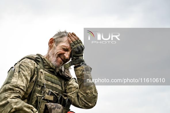 A serviceman of the 65th Separate Mechanized Brigade of the Armed Forces of Ukraine is seen during combat coordination in Ukraine, on Septem...