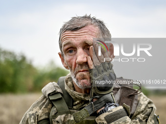 A serviceman of the 65th Separate Mechanized Brigade of the Armed Forces of Ukraine is seen during combat coordination in Ukraine, on Septem...