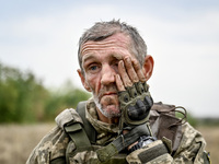 A serviceman of the 65th Separate Mechanized Brigade of the Armed Forces of Ukraine is seen during combat coordination in Ukraine, on Septem...