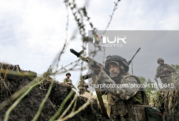 A serviceman of the 65th Separate Mechanized Brigade of the Armed Forces of Ukraine takes aim during combat cohesion in Ukraine, on Septembe...