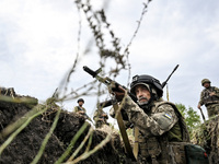 A serviceman of the 65th Separate Mechanized Brigade of the Armed Forces of Ukraine takes aim during combat cohesion in Ukraine, on Septembe...