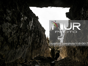 A serviceman of the 65th Separate Mechanized Brigade of the Armed Forces of Ukraine walks through the trenches during combat coordination in...