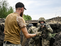 In Ukraine, on September 12, 2024, a combat training instructor (call sign ''Vokha'') (L) is pictured during the combat coordination of the...