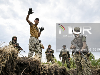 A combat training instructor (call sign ''Vokha'') (2nd L) is pictured during the combat coordination of the 65th Separate Mechanized Brigad...