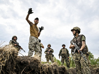 A combat training instructor (call sign ''Vokha'') (2nd L) is pictured during the combat coordination of the 65th Separate Mechanized Brigad...