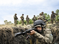 A serviceman of the 65th Separate Mechanized Brigade of the Armed Forces of Ukraine takes aim during combat cohesion in Ukraine, on Septembe...