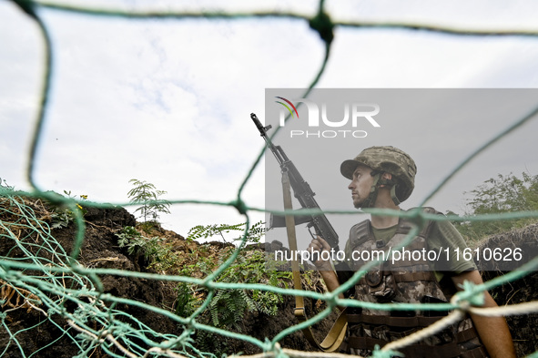 A serviceman of the 65th Separate Mechanized Brigade of the Armed Forces of Ukraine is seen through the net during combat coordination in Uk...