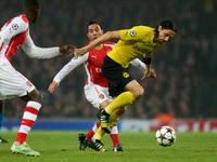 Santi Cazorla of Arsenal competes for the ball with Neven Subotic of Borussia Dortmund during the UEFA Champions League Group D soccer match...