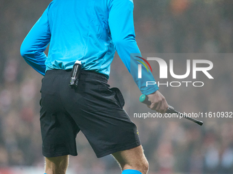 An assistant referee holds the Electronic Beeper Soccer Referee Flag during the UEFA Champions League Group D soccer match between Arsenal a...