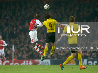 Yaya Sanogo of Arsenal competes for the ball with Neven Subotic of Borussia Dortmund during the UEFA Champions League Group D soccer match b...