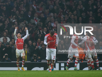 Alexis Sanchez of Arsenal gestures in celebration after scoring the 2-0 goal for Arsenal during the UEFA Champions League Group D soccer mat...