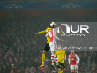 Pierre-Emerick Aubameyang of Borussia Dortmund competes for the ball with Nacho Monreal of Arsenal during the UEFA Champions League Group D...