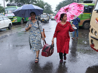 Women hold umbrellas as they walk in the monsoon rain in Kolkata, India, on September 26, 2024. (