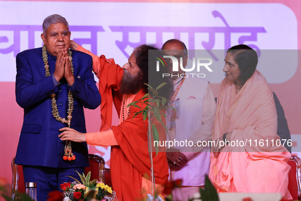 Vice President Jagdeep Dhankhar is welcomed by the Spiritual Head of Parmarth Niketan Ashram, Chidanand Saraswati, and religious leader Sadh...