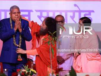 Vice President Jagdeep Dhankhar is welcomed by the Spiritual Head of Parmarth Niketan Ashram, Chidanand Saraswati, and religious leader Sadh...