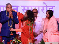 Vice President Jagdeep Dhankhar is welcomed by the Spiritual Head of Parmarth Niketan Ashram, Chidanand Saraswati, and religious leader Sadh...