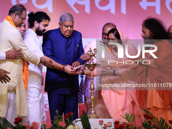 Vice President Jagdeep Dhankhar, Spiritual Head of Parmarth Niketan Ashram Chidanand Saraswati, and religious leader Sadhvi Ritambhara light...