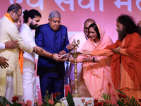 Vice President Jagdeep Dhankhar, Spiritual Head of Parmarth Niketan Ashram Chidanand Saraswati, and religious leader Sadhvi Ritambhara light...