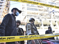 People and rescuers gather at the site of an Israeli airstrike that targets an apartment on al-Qaem Street in Beirut's southern suburbs on S...