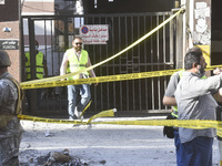 People and rescuers gather at the site of an Israeli airstrike that targets an apartment on al-Qaem Street in Beirut's southern suburbs on S...