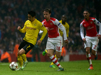 Shinji Kagawa of Borussia Dortmund is closely followed by Nacho Monreal of Arsenal during the UEFA Champions League Group D soccer match bet...