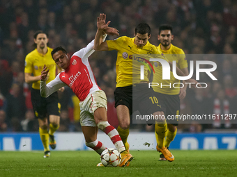 Alexis Sanchez of Arsenal vies for the ball with Henrikh Mkhitaryan of Borussia Dortmund during the UEFA Champions League Group D soccer mat...